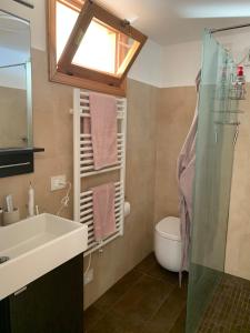 a bathroom with a sink and a toilet and a window at Suite Incanto lago di Garda in Torri del Benaco