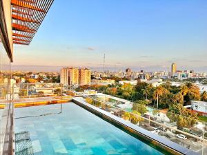 a large swimming pool on top of a building at Stylish Upscale Condo, Pool in Santo Domingo
