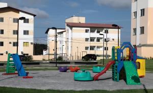 a playground with colorful play equipment in front of a building at Apartamento cop 30 in Marituba
