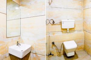a bathroom with a toilet and a sink at Hotel O The Park View Rooms in Surat