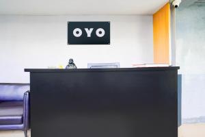 an office with a desk with an oo sign on the wall at Hotel O The Park View Rooms in Surat