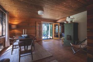 a living room with a table and a fireplace at Stay North - Veteran's House in Kiljava