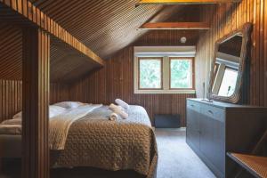a bedroom with a bed with a teddy bear on it at Stay North - Veteran's House in Kiljava