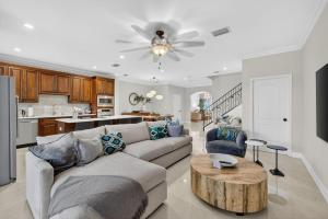 a living room with a couch and a table at Daisy Elegance Townhouse Steps from The Beach in Pompano Beach