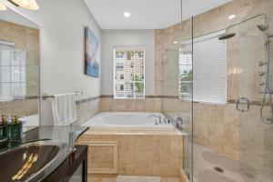 a bathroom with a tub and a sink and a shower at Daisy Elegance Townhouse Steps from The Beach in Pompano Beach +31 photos
