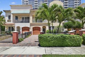 a house with palm trees in front of a building at Daisy Elegance Townhouse Steps from The Beach in Pompano Beach