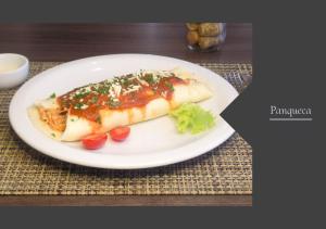 a white plate with two hot dogs on a table at Hotel Locatelli in Lajeado