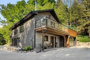 a large house with a balcony on top of it at Evergreen Escape in Collingwood