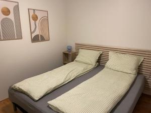 two beds sitting next to each other in a room at HB HolidayHomes - The White Pearl in Tromsø