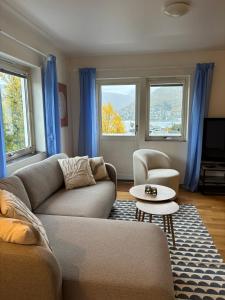 a living room with a couch and two chairs at HB HolidayHomes - The White Pearl in Tromsø