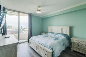 a bedroom with blue walls and a bed with a window at The Driftwood Oasis in Biloxi +13 photos