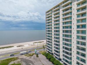 an apartment building with the beach in the background at The Driftwood Oasis in Biloxi