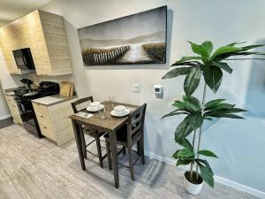 a dining room with a table and a plant at Verdant Luxe Studio in Des Moines