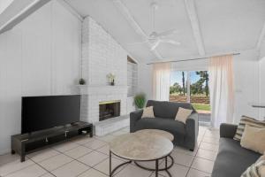 a living room with a couch and a fireplace at Oak and Fairway in Riverside