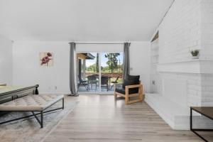 a living room with white walls and a fireplace at Oak and Fairway in Riverside