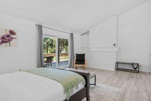 a bedroom with a bed and a large window at Oak and Fairway in Riverside