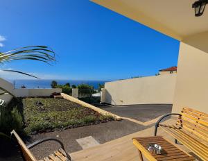 a patio with a bench and a view of the ocean at Moradia Abreu in Santa Cruz