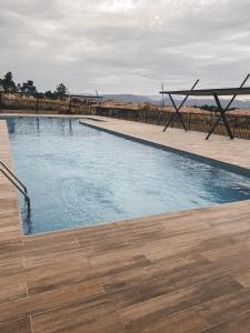a large swimming pool with a wooden deck at Havre de Paix Résidence Standing in Roquebrune-sur-Argens