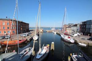 a group of boats are docked in a harbor at Pension Klabautermann in Stralsund