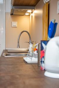 a kitchen sink with a dish drying rack next to it at Centrino in Burgas City
