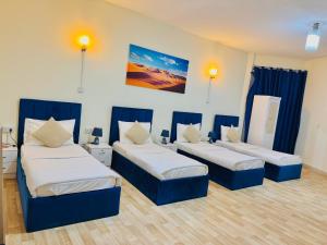 a room with three beds with blue dividers at VIP Residence - Exclusively for Ladies in Dubai