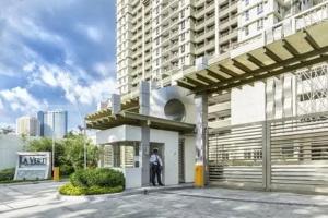 a person standing in front of a building at 1BR LaVerti Cloud Nine Suite Family Affordable Staycation in Manila