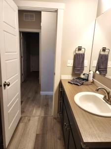 a bathroom with a sink and a mirror at StarLuxe Stay and Play in Star +11 photos