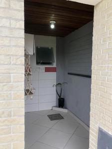 a room with a brick wall and a ceiling at Tranquilidade e Ótima localização in São José +19 photos