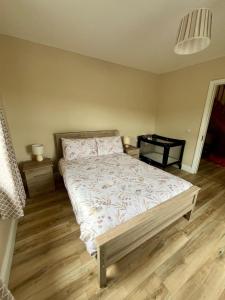 a bedroom with a large bed and a table at Loophead SelfCatering Cottage SensoryAccessible in Kilrush +25 photos