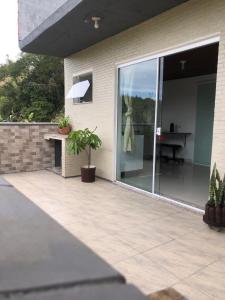 a sliding glass door on a house with a patio at Tranquilidade e Ótima localização in São José
