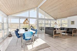 a living room with a table and blue chairs at 6824 Allinge - Hammervænget 4 in Allinge