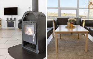 a living room with a wood stove in a living room at 6824 Allinge - Hammervænget 4 in Allinge