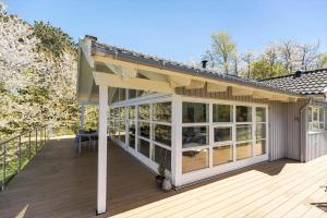 a screened in porch with a roof on a house at 6824 Allinge - Hammervænget 4 in Allinge