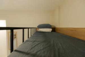 a bed sitting on the side of a room at SUH Flamengo 14 Modern Studio in Rio de Janeiro