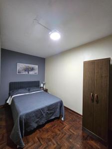 a bedroom with a bed and a cabinet in it at Casa Navarra in Lima