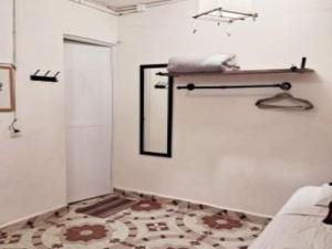 a white room with a bed and a mirror at Cozy Studio Wkitchen Isla Mujeres Punta Norte in Isla Mujeres