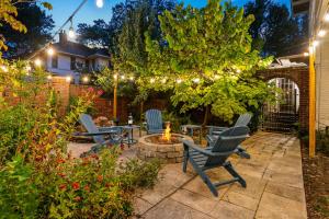 a patio with chairs and a fire pit with lights at Pool Outdoor TV Fire Pit Game Room in Memphis