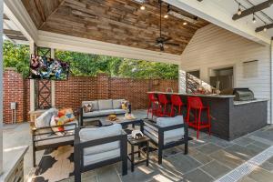 an outdoor patio with a bar and a grill at Pool Outdoor TV Fire Pit Game Room in Memphis
