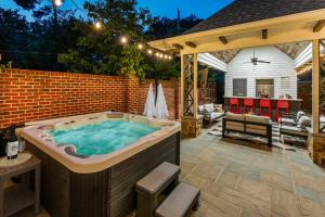 a hot tub in a backyard with a gazebo at Pool Outdoor TV Fire Pit Game Room in Memphis