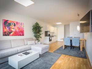 a living room with a couch and a table at Modern City Apartment near Vienna Central Station in Vienna +18 photos
