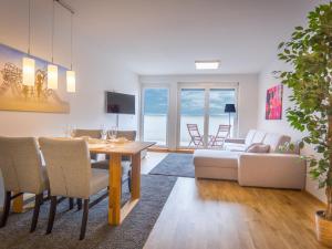 a dining room and living room with a table and chairs at Modern City Apartment near Vienna Central Station in Vienna