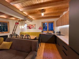 a kitchen and living room with a couch and a table at Apartments K.I.D.S. in Vlasic