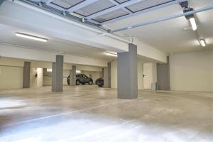 an empty parking garage with a car parked in it at Palazzo Cavalieri business&relax 10Galvano in Castiglione delle Stiviere