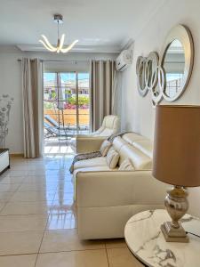 a living room with a couch and a table with a lamp at Terrazas del Duque II Hideaway in Adeje
