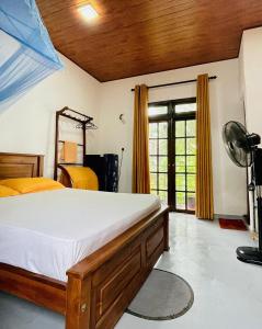a bedroom with a bed and a fan and a window at Ceylon Waves Weligama in Weligama +12 photos