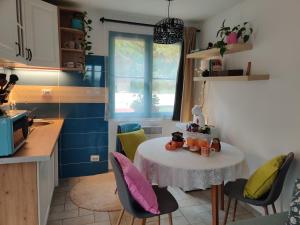 a small kitchen with a table and chairs in a room at Healing Garden Leányfalu in Leányfalu +7 photos