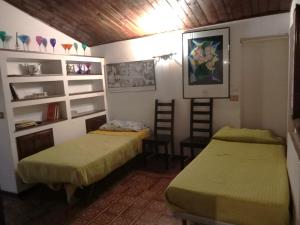 a room with two beds and a chair and shelves at Casa di Tatiana in Senigallia