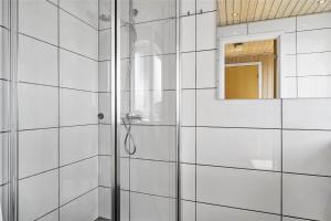 a shower with a glass door and a mirror at 6682 Allinge - Brunekulvej 2 E in Allinge