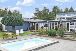 a house with a swimming pool in the yard at 2644 Nexø - Pilegårdsvejen 17 B in Neksø
