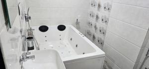 a white bathroom with a tub and a sink at Hotel Royal Elite in Vapi +47 photos